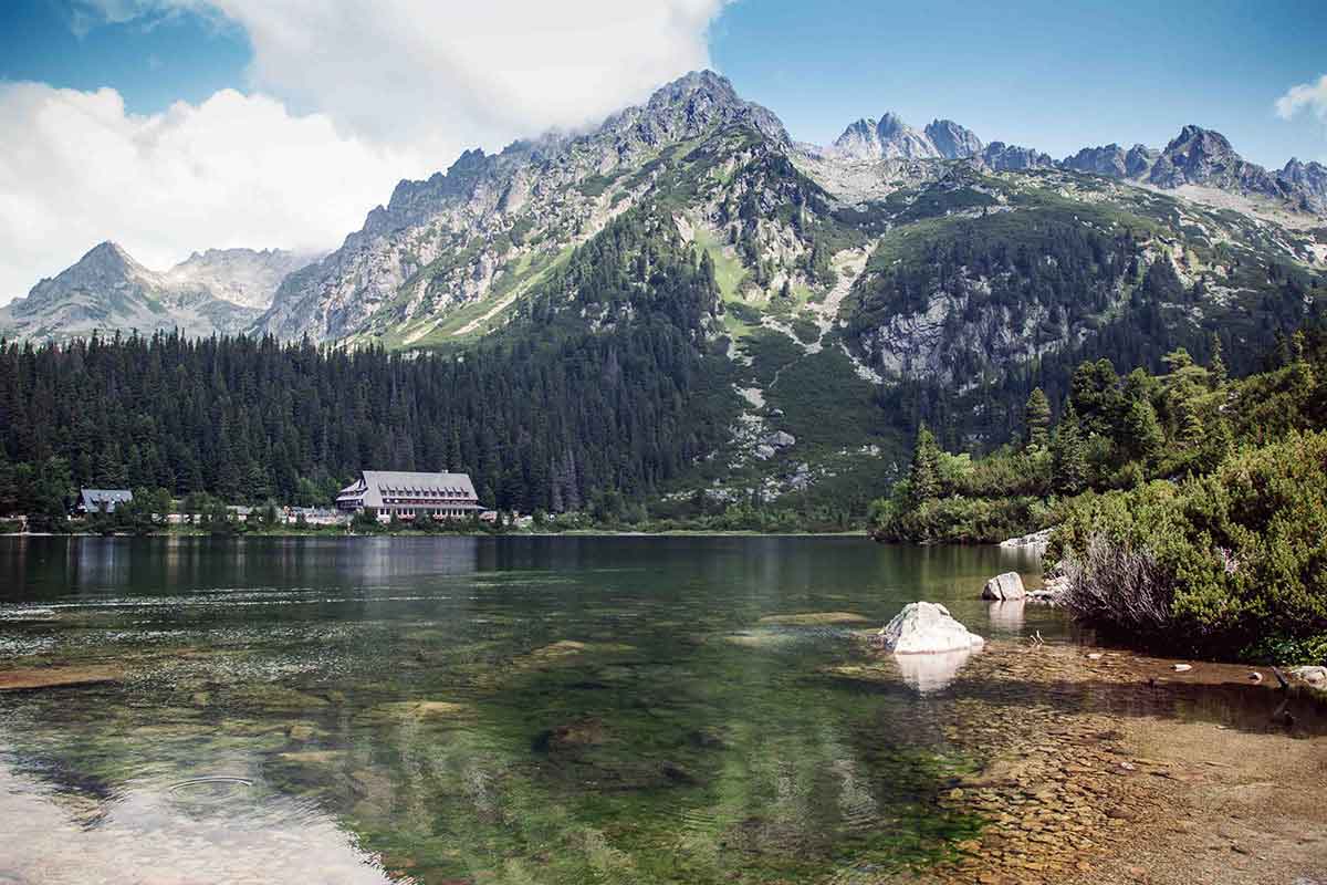 A resort in the mountains overlooking a lake with clear water